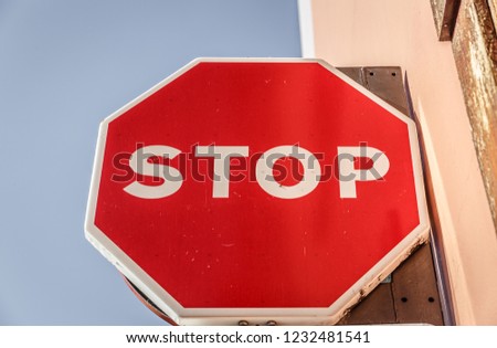 Foreground of a large stop sign, placed in an wall