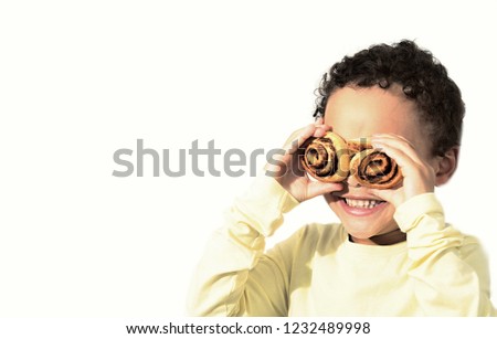 little boy having fun with some cakes stock photo