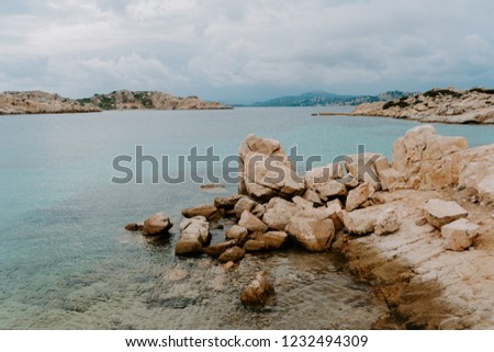Beautiful sardinian landscape view to mountains, hills, stones, trees, blue sea and little house