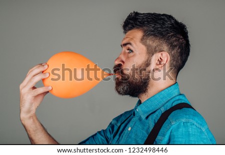 man. male with beard. brutal caucasian hipster with moustache. Mature hipster with beard. bearded man with orange balloon. Bearded brutal man. inflating balloon. bubble. great idea