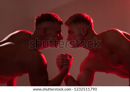 Strength skills. Twins men competing till victory. Twins competitors arm wrestling. Men competitors try to win victory or revenge. Revenge in sport. Fighting with strength.