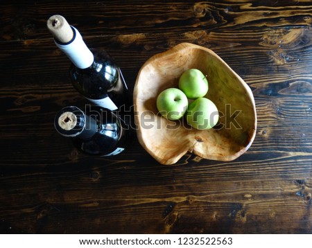 Two Dark Wine Bottles on Rustic Wooden Table with Apples Aerial View