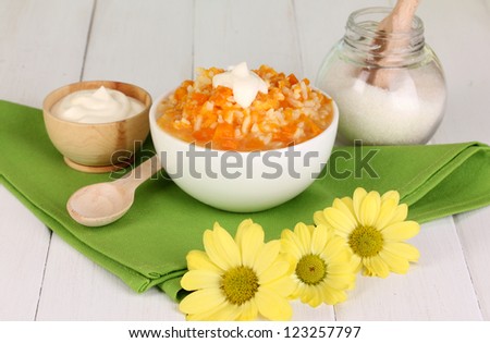 Useful pumpkin porridge in white plate on wooden table close-up