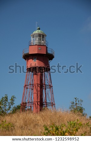 Sandhammaren red metall Lighthouse in the afternoon. Stock photo.