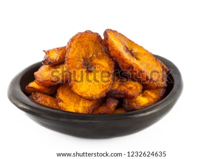 Deep fried ripe plantain slices isolated in white background Royalty-Free Stock Photo #1232624635