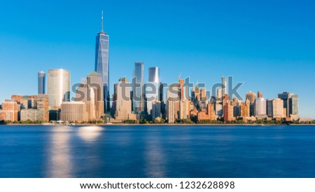 View of the skyline of downtown Manhattan over Hudson River under blue sky, at sunset, viewed from New Jersey, in New York City, USA Royalty-Free Stock Photo #1232628898