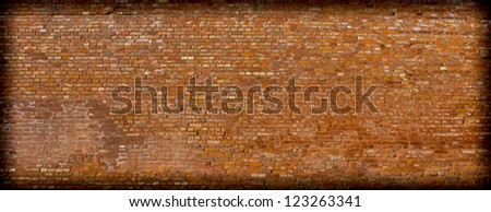 Background texture of a brick wall with darker vignette