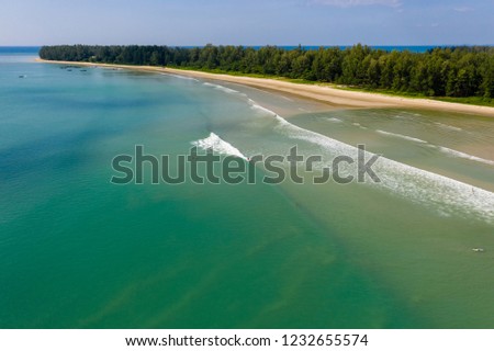 Aerial view of surfers in shallow water in Khao Lak, Thailand