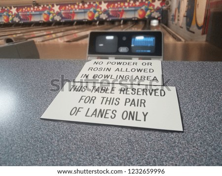 this table reserved and no powder or rosin allowed signs in bowling alley