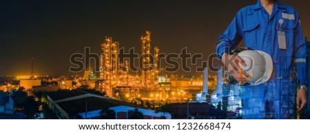 Technician stand hand holding safety helmet with blue uniform on petrochemical industrial background, Double exposure Royalty-Free Stock Photo #1232668474