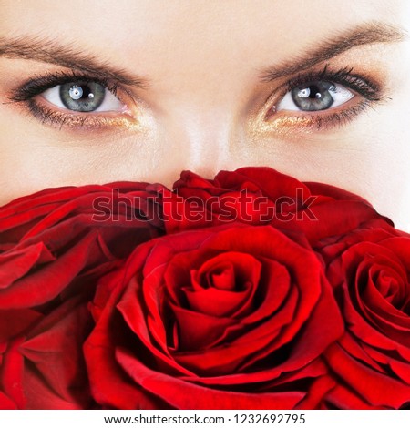 Beautiful young woman with red roses