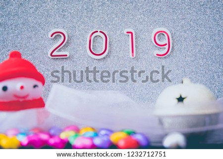 Christmas holidays background - silver ribbon, glitters and bokeh effect on white background, copy space