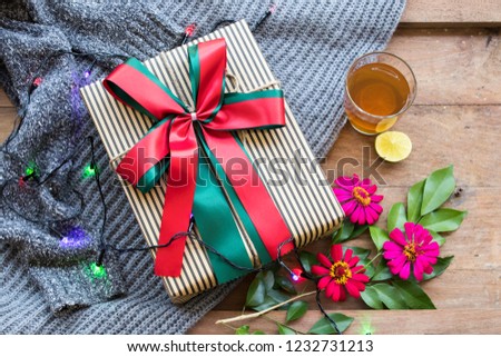 gift box for special in christmas and happy new year festival day with sweater knitting wool  of lifestyle woman in winter season and hot lemon tea for health care on background wooden