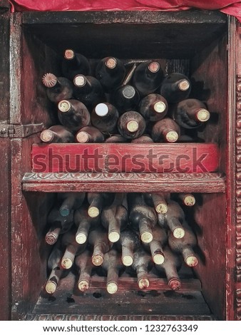 old wine bottles with a lot of dust. Vertical picture of ancient wines