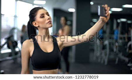 Young sport woman taking selfie after gym workout, social media platform
