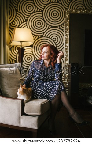 Woman stroking a cat at home