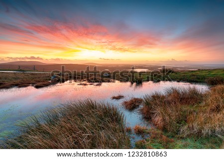 Stunning sunrise over peat bogs at North Uist in the Western Isles of Scotland Royalty-Free Stock Photo #1232810863