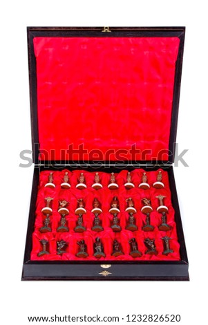 Box with chess pieces on white background