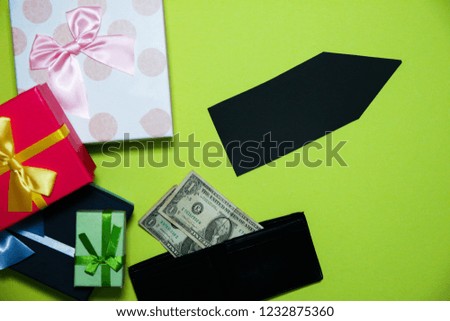 Black Friday concept photo with an arrow. Present boxes for Birthday parties. Sale and discount. Christmas shopping ideas. Special offer. Copy space. Cheap prices. Dollars money in wallet.