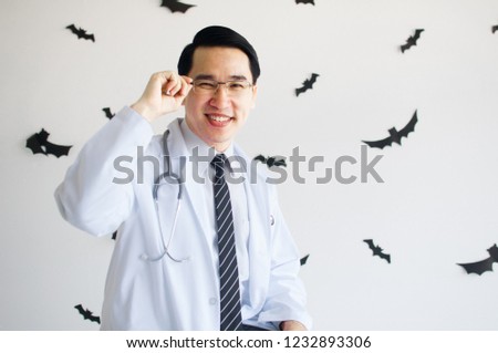 A  male doctor with a stethoscope and many bats on white background 