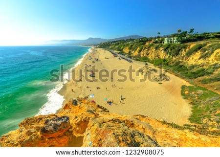 Aerial view of panoramic Point Dume State Beach from Point Dume promontory on Malibu coast, Pacific Ocean in CA, United States. California West Coast. Blue sky, summer season in sunny day. Copy space. Royalty-Free Stock Photo #1232908075