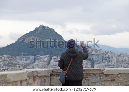 A tourist takes a picture from the Acropolis of Athens facing over the city.

Acropolis of Athens, Greece. 30/01/17