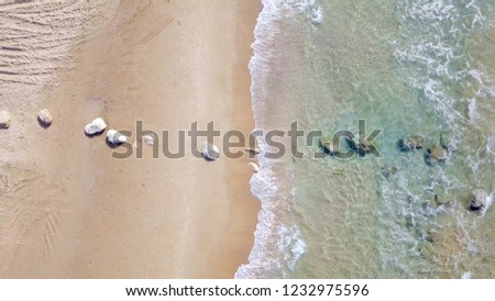 Beautiful clean empty beach with small waves breaking on the sandy beach - Aerial image.