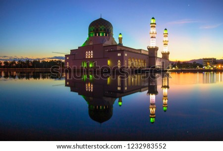 Reflection of Likas Mosque during dawn time with clear sky as the background
