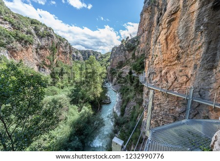 Hiking trail through Sierra de Guara, iron bridges over a beauti Royalty-Free Stock Photo #1232990776
