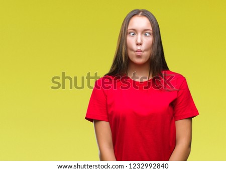 Young beautiful caucasian woman over isolated background making fish face with lips, crazy and comical gesture. Funny expression.