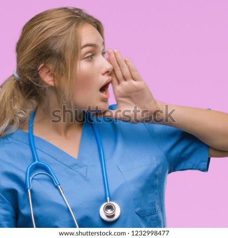 Young caucasian doctor woman wearing surgeon uniform over isolated background shouting and screaming loud to side with hand on mouth. Communication concept.