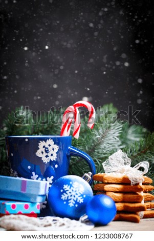 Merry Christmas and happy New year. Cup cocoa, cookies, gifts and fir-tree branches on a wooden table. Selective focus. Christmas background. Background with copy space.