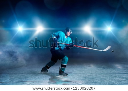 Hockey player with stick and puck makes a throw
