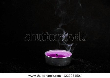 smoke from an extinguished candle on a black background