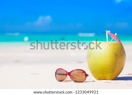 picture of fresh coconut cocktail on tropical beach