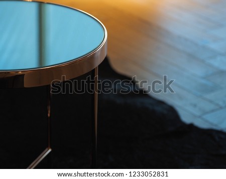glass coffee table on a dark carpet
