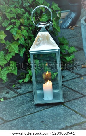 A candle is lit in a lamp Royalty-Free Stock Photo #1233053941