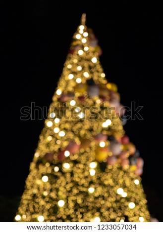 Defocused decorated christmas tree with bokeh lights.