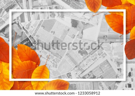 Lots of blurred newspapers and decorated paper frame with autumn leaves, creative news background with copy space