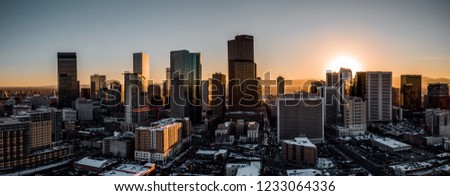Aerial drone photo - City of Denver Colorado at sunset.  Rocky Mountains on the horizon