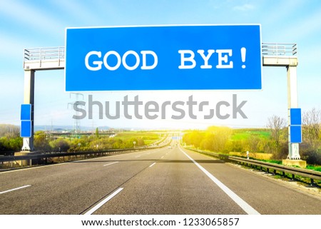 Blue freeway sign over the road on sunny day with words Good Bye on it