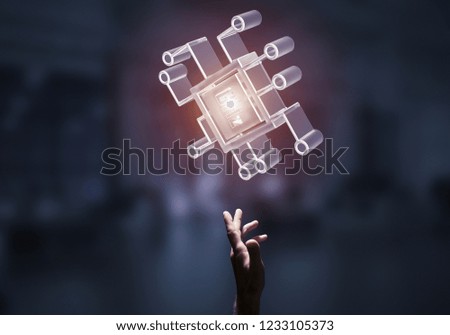Close of businessman hand touching glass chip icon on dark office background. Mixed media