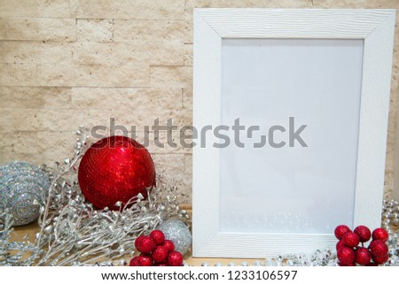 Red and silver Christmas balls with glittering pailletes and red berries. Free space for text. Mock up, white frame for text. 