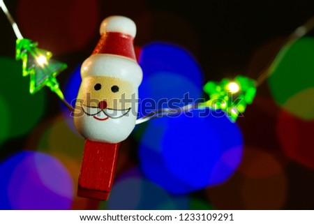 Christmas clip with Santa Claus and colored lights on the background. 

