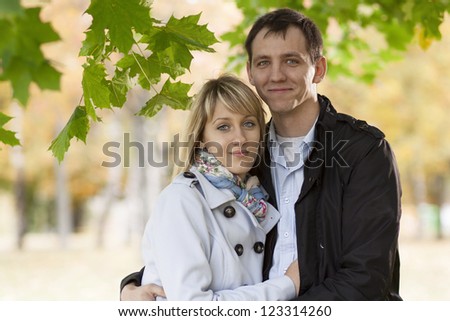 Picture of happy people spending fun time together in beautiful autumn park