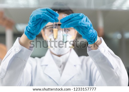 Female scientist looking at the scientific sample in the laboratory Royalty-Free Stock Photo #1233157777