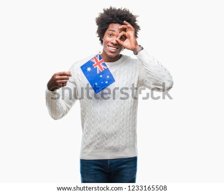 Afro american man flag of Australia over isolated background with happy face smiling doing ok sign with hand on eye looking through fingers