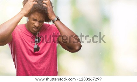 Afro american man over isolated background suffering from headache desperate and stressed because pain and migraine. Hands on head.
