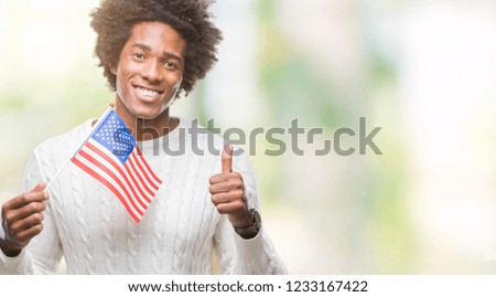 Afro american man flag of United States of America over isolated background happy with big smile doing ok sign, thumb up with fingers, excellent sign