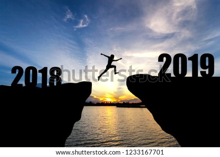 man jumping from 2018 to 2019 Royalty-Free Stock Photo #1233167701